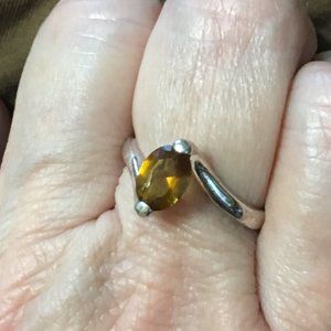 Silver tone ring with amber colored glass stone